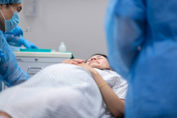 istock Pregnant woman lays on operating table before receiving cesarean section 1171128903