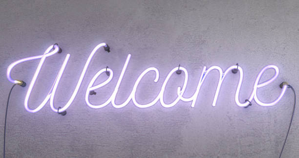 Neon pink sign saying the word Welcome stock photo