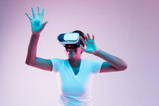 istock Young african-american woman's using VR-glasses in neon light 1171129078