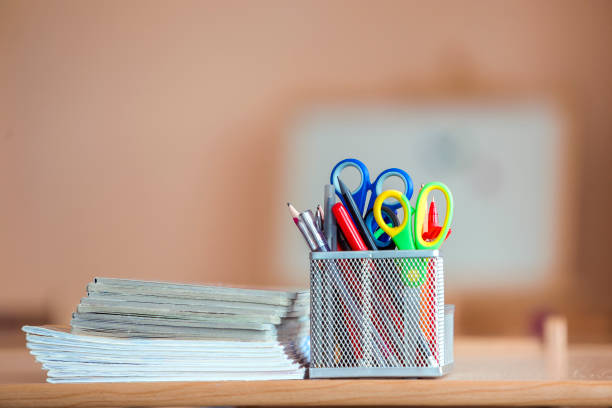 istock Stack of notebooks and stationery arrangement in classroom or office on copy space background 1171130244