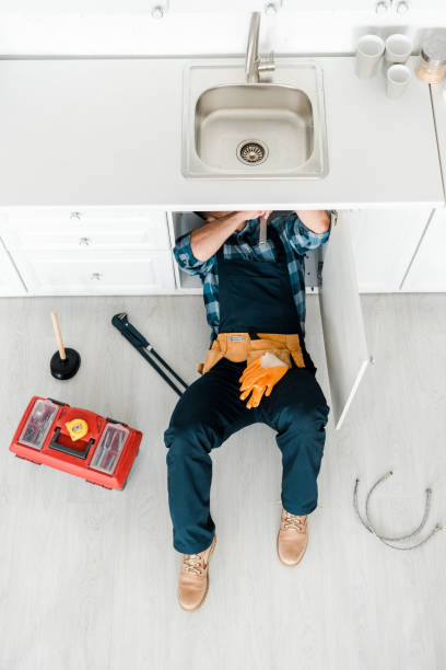 top view of handyman lying on floor while working near toolbox top view of handyman lying on floor while working near toolbox Plumber stock pictures, royalty-free photos & images