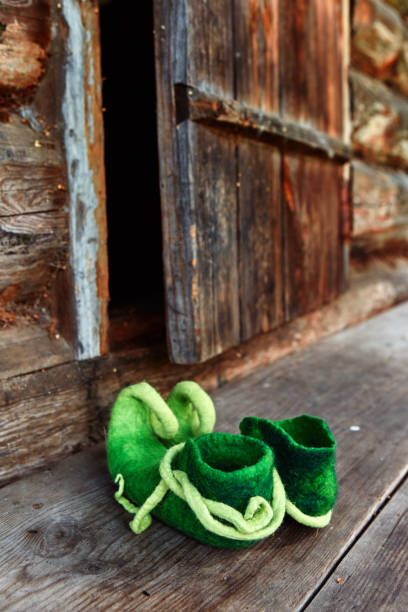 fairy creature elf or forest dwarf left his shoes on the threshold of an old wooden house near the front door. - doormat door christmas holiday imagens e fotografias de stock