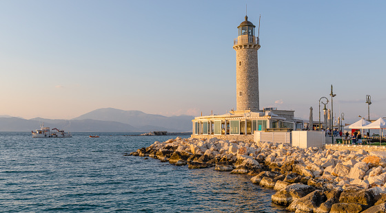 Lighthouse on the territory of the ancient fortress of Antirio on the coast of the Gulf of Corinth opposite the city of Patras.