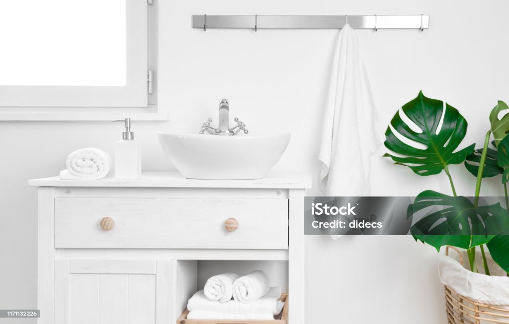 Simple bathroom cabinet with various supplies. Storage and organizing concept Bathroom Stock Photo