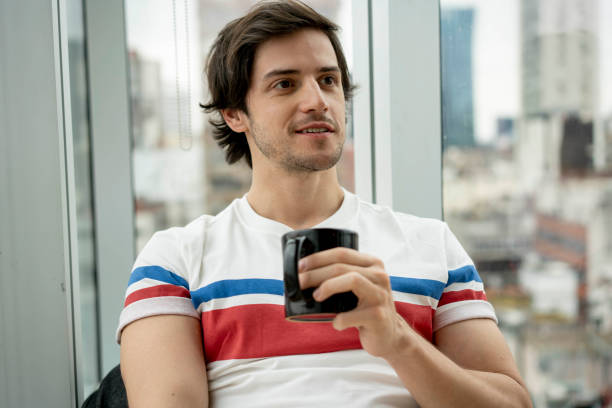 istock Handsome young man at the office relaxing and drinking a cup of tea 1171132353