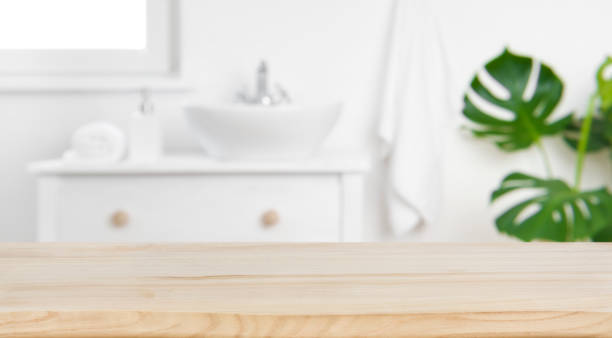 Wood tabletop on blur bathroom background, design key visual layout Wood tabletop on blur bathroom background, design key visual layout sink photos stock pictures, royalty-free photos & images