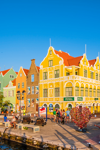 Penha Building, constructed in 1708, and other beautiful buildings in the district of Punda in Willemstad, the capital city of Curaçao, an island in the southern Caribbean Sea. People.