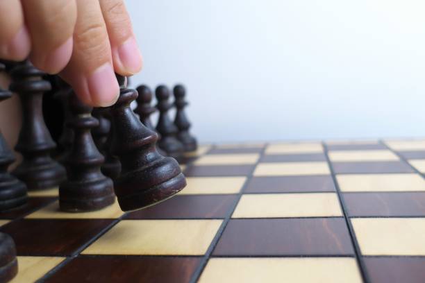 istock Hand and wooden chessboard, isolated on white background 1171133112
