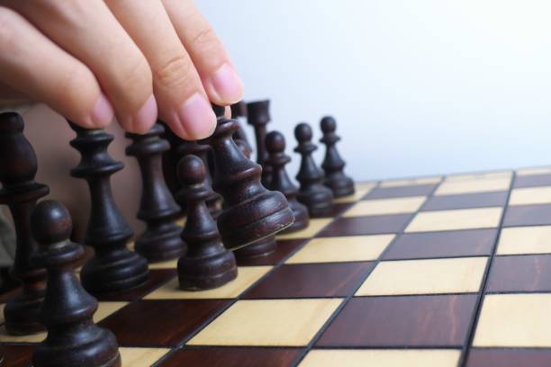 istock Hand and wooden chessboard, isolated on white background 1171133142