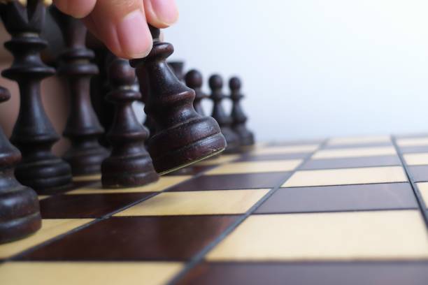 istock Hand and wooden chessboard, isolated on white background 1171133149