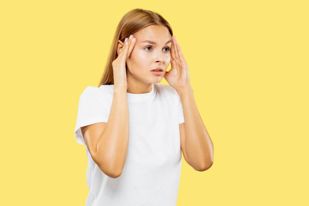 istock Caucasian young woman's half-length portrait on yellow background 1171133164