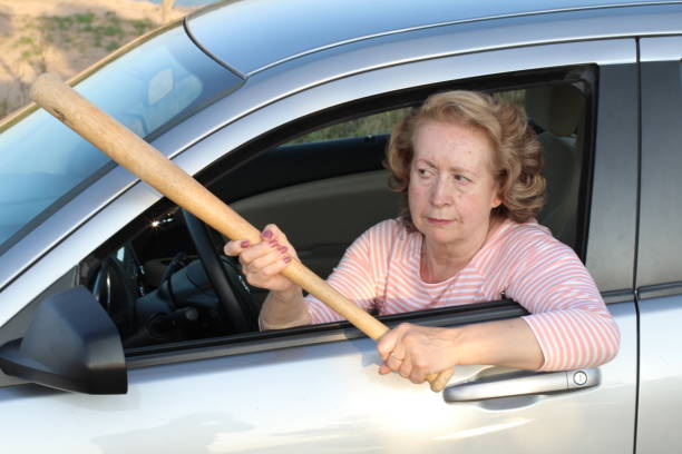 istock Angry mature female driver holding baseball bat 1171134549