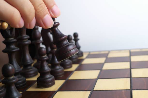 istock Hand and wooden chessboard, isolated on white background 1171135137