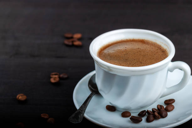 istock Cup of coffee on a black wooden table 1171135183