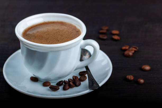 istock Cup of coffee on a black wooden table 1171135186