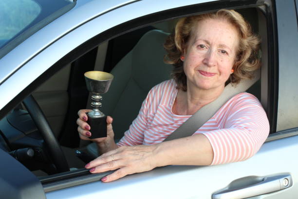 istock Senior female driver holding a trophy 1171135348