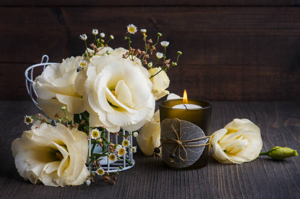 istock Yellow lisianthus flowers and lit candle 1171136760