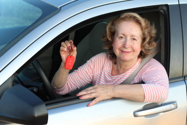 istock Cute mature female driver holding car keys 1171138829