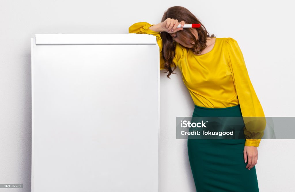 girl teacher sleeping in the classroom the teacher was upset in the classroom at the whiteboard. girl sleeping in the audience. mocap on a whiteboard Boredom Stock Photo