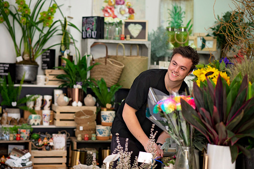 A florist working in his store.