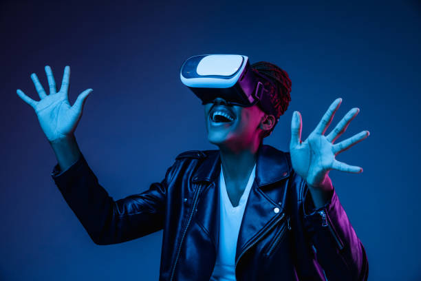 istock Young african-american woman's using VR-glasses in neon light 1171147506
