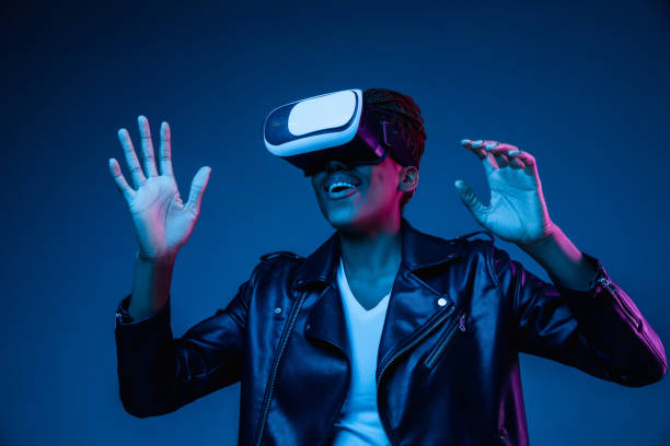 istock Young african-american woman's using VR-glasses in neon light 1171147507