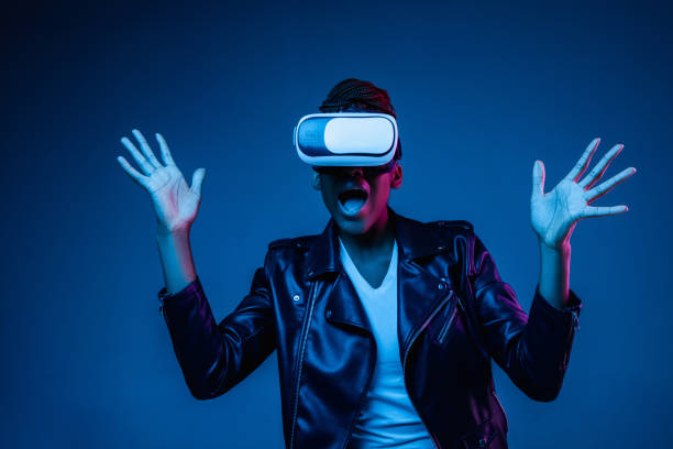 istock Young african-american woman's using VR-glasses in neon light 1171147512