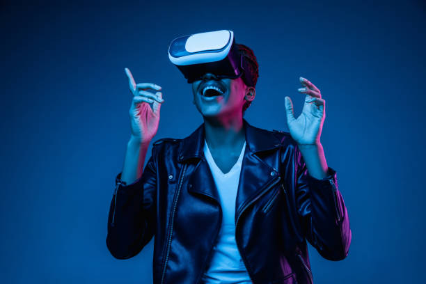 istock Young african-american woman's using VR-glasses in neon light 1171147514