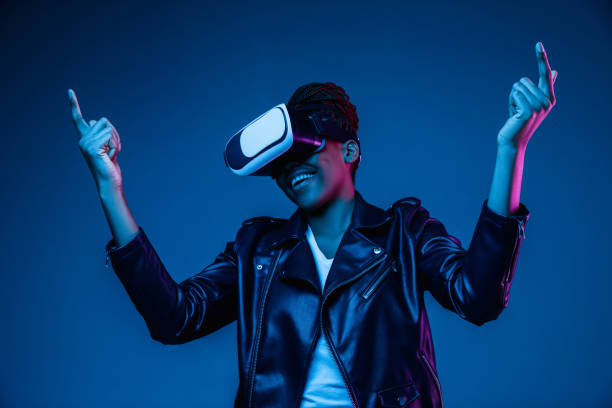 istock Young african-american woman's using VR-glasses in neon light 1171147529