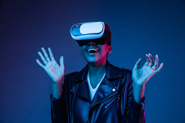 istock Young african-american woman's using VR-glasses in neon light 1171147534