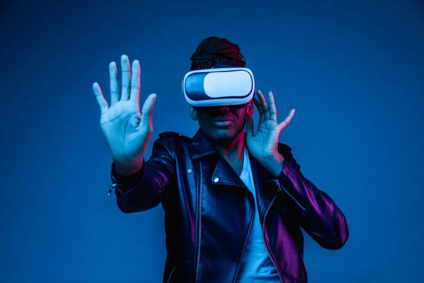 istock Young african-american woman's using VR-glasses in neon light 1171147545