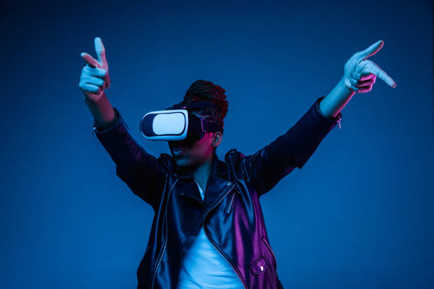 istock Young african-american woman's using VR-glasses in neon light 1171147551