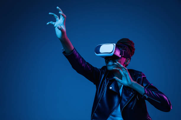 istock Young african-american woman's using VR-glasses in neon light 1171147560
