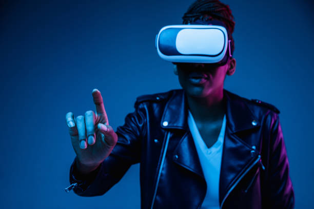 istock Young african-american woman's using VR-glasses in neon light 1171147561