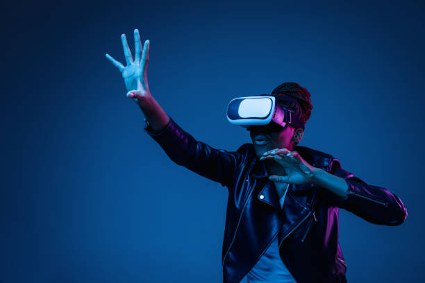 istock Young african-american woman's using VR-glasses in neon light 1171147577