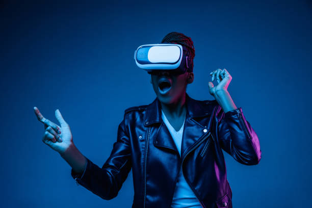 istock Young african-american woman's using VR-glasses in neon light 1171147583