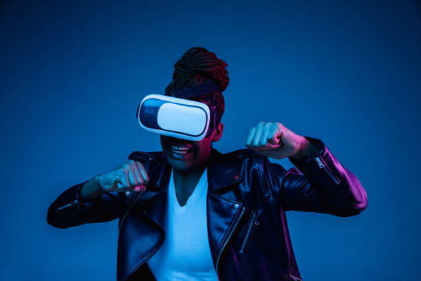 istock Young african-american woman's using VR-glasses in neon light 1171147590