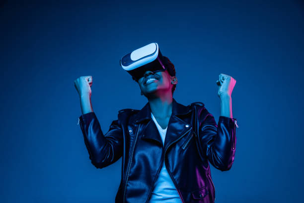 istock Young african-american woman's using VR-glasses in neon light 1171147594