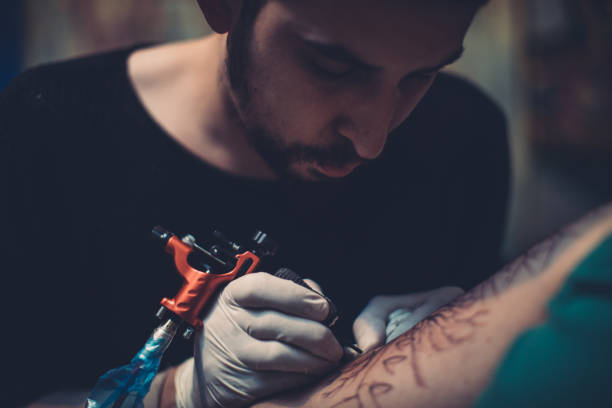 istock Artist tattooing young man in studio 1171149816