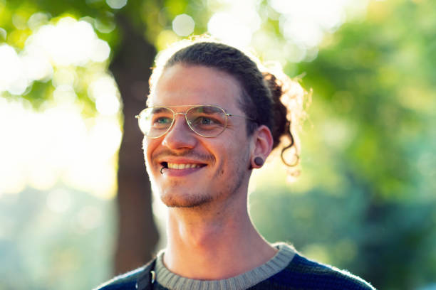 istock Pierced young guy in the park 1171151373