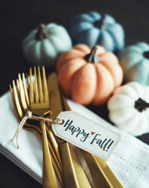 istock Thanksgiving Table Setting Background with Pumpkins and Gold Cutlery 1171151796