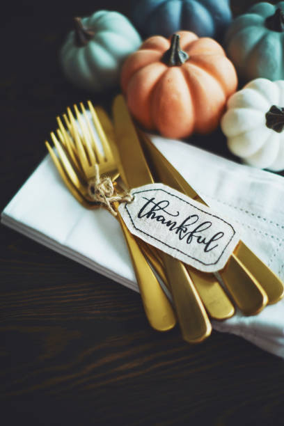 istock Thanksgiving Table Setting Background with Pumpkins and Gold Cutlery 1171151983