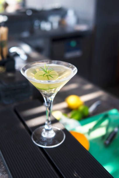 A close-up photo of a refreshing lemon mint iced drink on a sunny table. The glass is garnished with lemon slices and mint, emphasizing freshness and summer vibes.