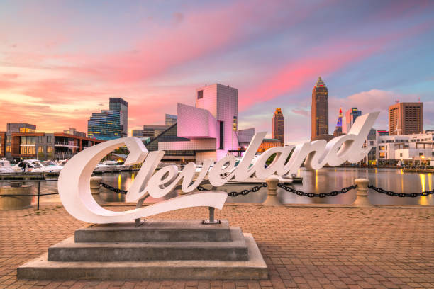 Cleveland, Ohio, USA Skyline August 10, 2019 - Cleveland, Ohio, USA: The landmark skyline of downtown Cleveland from Voinovich Bicentennial Park with the iconic sign in the early morning. cleveland ohio photos stock pictures, royalty-free photos & images