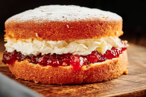 istock Whole Victoria sponge cake on a rustic chopping board. 1171160752