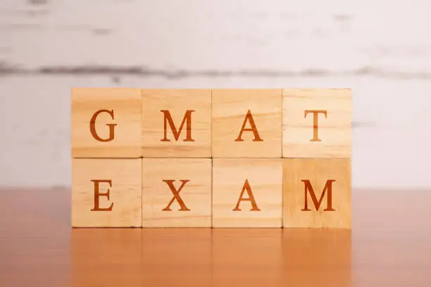 Photo of GMAT. Graduate Management Admission Test or exam in wooden block letters