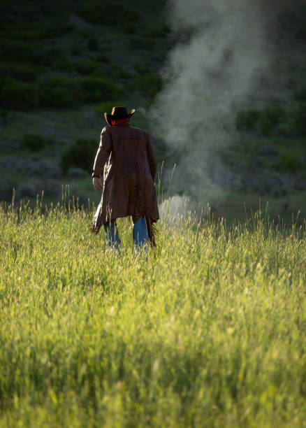 istock Senior cowboy walking thru grass 1171162360