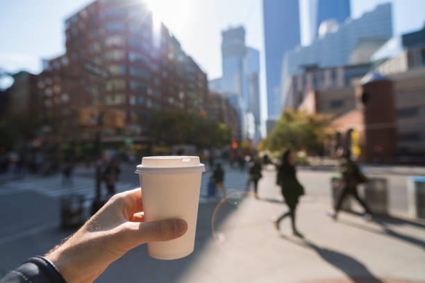 Man holding a coffee cup in New York City stock photo