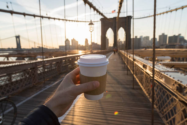 Man holding a coffee cup in New York City stock photo