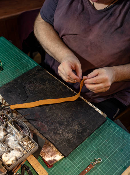 istock A man sews a leather product in a workshop. 1171166673